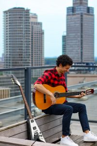 dating profile photo of a man playin guitar in Amsterdam
