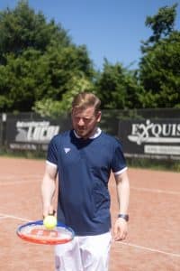 dating profile photo of a man playing tennis in Amsterdam